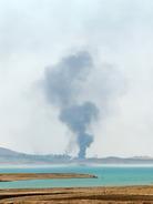 Smoke rises during airstrikes targeting Islamic State militants at the Mosul Dam outside Mosul, Iraq, on Monday. Kurdish forces say they have retaken the dam, but the militants insist they still have control. Khalid Mohammed/AP