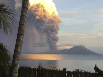 Smoke billows from Mount Tavurvur after an eruption in Kokopo, east New Britain, Papua New Guinea, on Friday. The eruption has caused some nearby residents to be evacuated and some flights to be rerouted. Jason Tassell/AP
