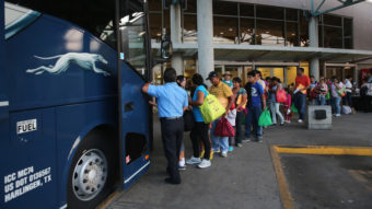 Immigrants board a bus after being released from U.S. Border Patrol detention in Texas last month. An immigration judge says the Obama administration's "fast-tracking" effort means many people go into court without an attorney, opening a door to future problems. John Moore/Getty Images
