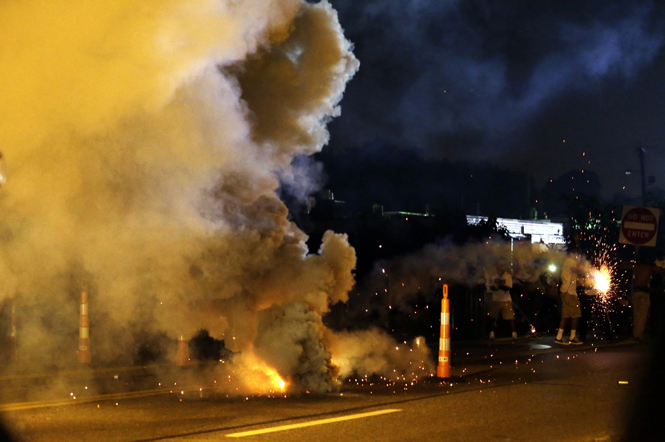 Teargas is deployed after police were fired upon Monday in Ferguson, Mo. Jeff Roberson/AP