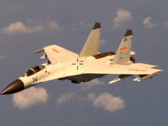 This handout photo provided by the Office of the Defense Secretary (OSD), taken Aug. 19, 2014, shows a Chinese fighter jet that the White House said Friday conducted a "dangerous intercept" of a U.S. Navy surveillance and reconnaissance aircraft. Uncredited/AP