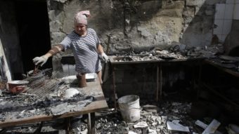 A woman removes debris from a cafe that was destroyed during fighting between Ukrainian forces and pro-Russian militants Aug. 5 in the eastern Ukrainian city of Slavyansk, in the region of Donetsk. Anatolii Stepanov/AFP/Getty Images