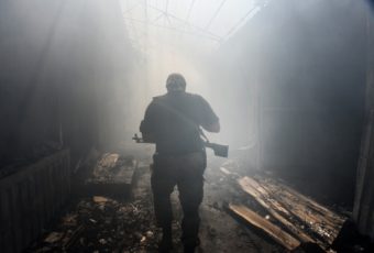 A Pro-Russian rebel walks in a passage at the local market damaged by shelling in Petrovskiy district in the eastern Ukrainian town of Donetsk. Mstislav Chernov/AP