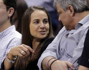 The San Antonio Stars' Becky Hammon, seen here attending a Spurs playoff game, has been hired as a full-time assistant coach, joining the NBA's reigning champions for next season. Eric Gay/AP