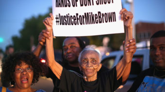 Creola McCalister, 88, protests the killing of teenager Michael Brown on Tuesday at a rally outside Greater St. Mark Family Church. Brown's death Saturday has sparked both peaceful rallies and violence this week. Scott Olson/Getty Images