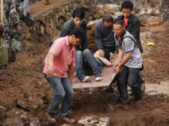 People carry an injured man through the debris in Ludian county in Zhaotong, a city in southwest China's Yunnan province on Monday.AFP/Getty Images