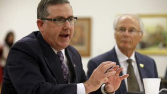 Kansas State University President Kirk Schulz (left) discusses the NCAA structure Thursday, as Wright State University President David R. Hopkins looks on. The NCAA Board of Directors approved a package of historic reforms Thursday that will give the nation's five biggest conferences the ability to unilaterally change some of the basic rules governing college sports. Michael Conroy/AP