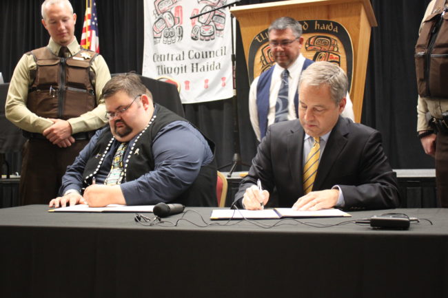 Central Council President Richard Peterson and Gov. Sean Parnell sign a Memorandum of Agreement on Monday at the Elizabeth Peratrovich Hall. (Photo by Lisa Phu/KTOO)