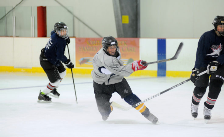 Corey Box unleashes a shot during a three-on-three Rocky Mountain Hockey School drill at Treadwell Ice Arena.