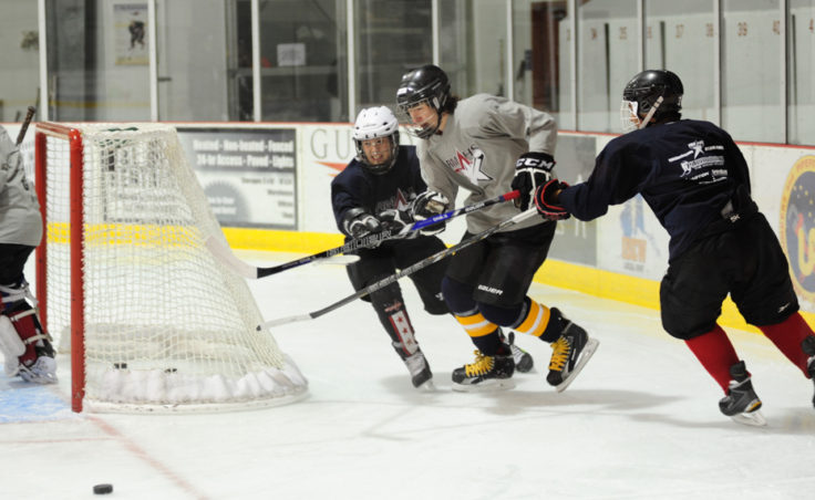 (from left) Culley Corrigan, Quin Gist and Shane Moller race for the puck during a three-on-three Rocky Mountain Hockey School drill at Treadwell Ice Arena.