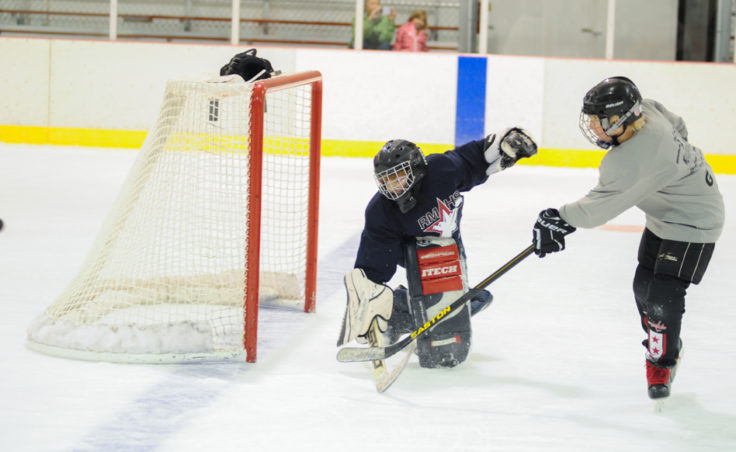 Goalie Zach Stagg turns back Paxton Wildes during a Rocky Mountain High School drill at Treadwell Ice Arena.