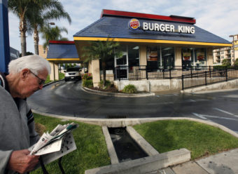 A pedestrian walks past a Burger King restaurant near downtown Los Angeles. Nick Ut/AP