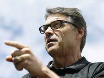 Texas Gov. Rick Perry speaks at the Des Moines Register's Political Soapbox at the Iowa State Fair on Tuesday. Late Friday, Perry was indicted on abuse-of-power charges. Charlie Neibergall/AP