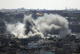 Smoke rises over Gaza City on Friday as Israel and Gaza militants resumed cross-border attacks after a three-day truce expired. Lefteris Pitarakis/AP