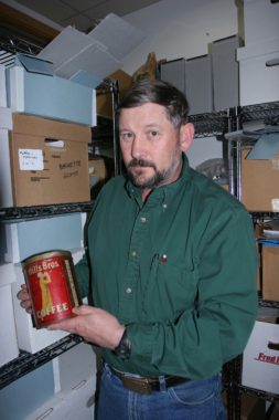 BLM archaeologist Steve Lanford with a Hills Bros. coffee can. (Photo by Craig McCaa/BLM)