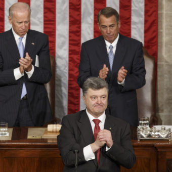 Ukrainian President Petro Poroshenko, joined by Speaker of the House John Boehner and Vice President Joe Biden, acknowledges lawmakers' applause after addressing a joint meeting of Congress. J. Scott Applewhite/AP