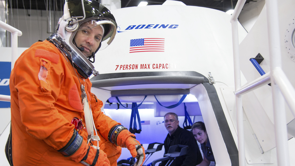 In an image provided by NASA, astronaut Randy Bresnik prepares to enter Boeing's CST-100 spacecraft for an evaluation at the company's Houston Product Support Center. NASA awarded Boeing with a $4.2 billion contract Tuesday. AP