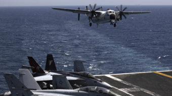 A U.S. military plane lands Aug. 11 on the U.S. Navy aircraft carrier USS George H.W. Bush in the Persian Gulf. U.S. public support of airstrikes against Islamic militants jumped sharply, according to a new poll, as President Obama prepares a strategy. Hasan Jamali/AP