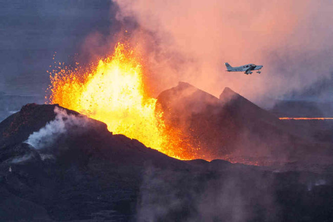 A plane flies over the Bardarbunga volcano as it spews lava and smoke in southeast Iceland on Sept. 14. The Bardarbunga volcano system has been rocked by hundreds of tremors a day since mid-August, prompting fears the volcano could explode. Bernard Meric/AFP/Getty Images