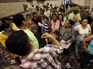 People wait to sign up for unemployment Sept. 3 at the Atlantic City Convention Center in Atlantic City, N.J., where thousands of workers at the closing Revel and Showboat casinos recently were laid off. Mel Evans/AP