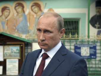 Russian President Vladimir Putin leaves the Life-giving Trinity church in Moscow, on Wednesday. Putin accused NATO of using the Ukraine crisis to "resuscitate itself." RIA NOVOSTI/Reuters/Landov