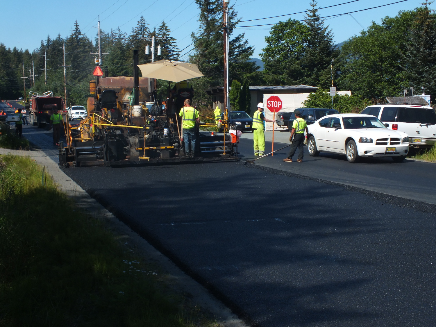 A rare opportunity for Juneau drivers to legally drive on the wrong side of the road as a spreader slowly makes its way along North Douglas Highway. (Photo by Matt Miller/KTOO)