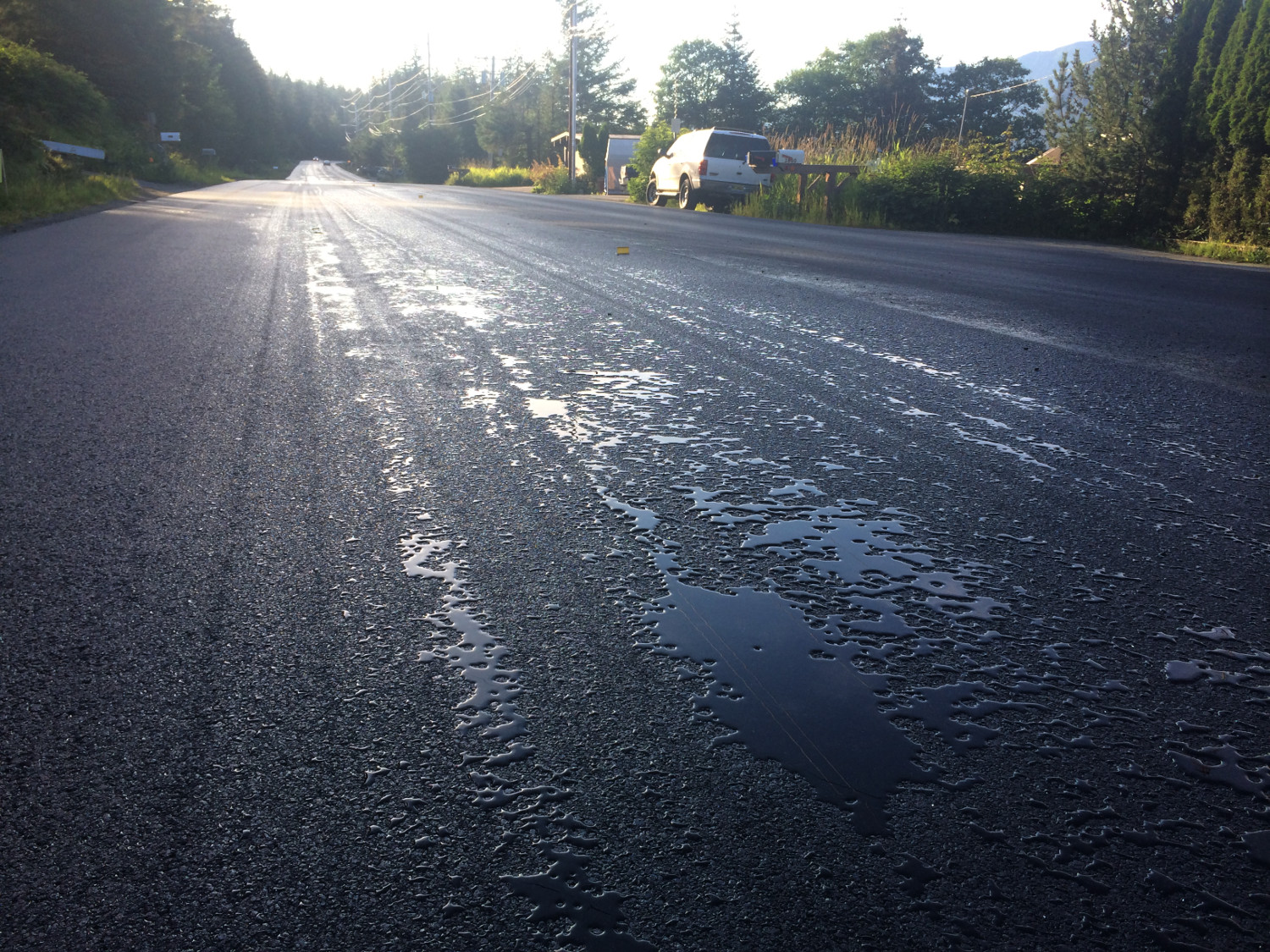 Some contractors apply a sealer after the asphalt has been applied and compacted. (Photo by Matt Miller/KTOO)