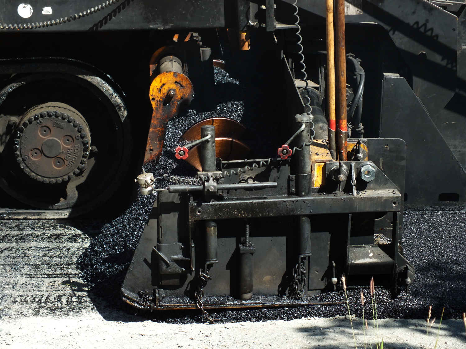 Scooping it up, spreading it out. (Photo by Matt Miller/KTOO)