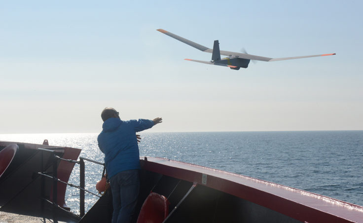 John Ferguson, an Unmanned Aircraft System operator for AeroVironment, releases a Puma All Environment UAS from the deck of the Coast Guard Cutter Healy during an exercise in the Arctic Aug. 23, 2014. The Puma is a small UAS designed for land and maritime operations. (Coast Guard photo by Petty Officer 1st Class Shawn Eggert)