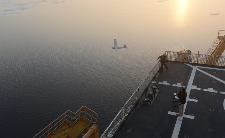 John Ferguson and Chris Thompson, Unmanned Aircraft System operators for AeroVironment, release a Puma All Environment UAS from the flight deck of the Coast Guard Cutter Healy during an exercise in the Arctic Aug. 18, 2014. The Coast Guard Research and Development Center and the National Oceanic and Atmospherc Administration evaluated the UAS for use in tracking a simulated oil spill during the exercise. (Coast Guard photo by Petty Officer 1st Class Shawn Eggert)