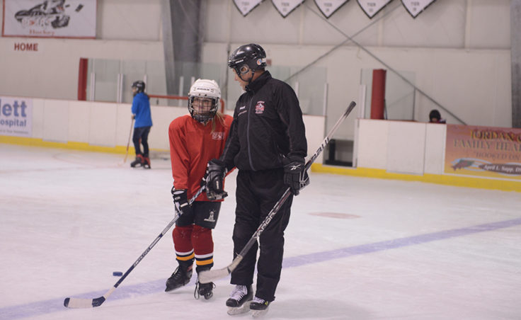 JDIA Coach Jason Kolhase works with Cara Wesley during a Learn to Play afternoon sponsored by the Juneau Douglas Ice Association and Treadwell Ice Arena.