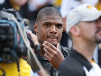 St. Louis Rams draft pick Michael Sam watches pregame festivities before the start of the South Dakota State-Missouri NCAA college football game on Saturday, in Columbia, Mo. Sam, the first openly gay player drafted by an NFL team, was released by the St. Louis Rams Saturday. L.G. Patterson/AP