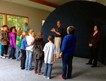 UAF Professor, Robby Herrick and Postdoctoral fellow, Emma Marcucci, address a 2nd grade class before the students enter the planetarium. Photo by Angela Denning.
