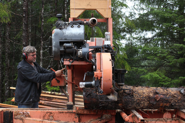 Chris Fry milling a spruce log. (Photo by Elizabeth Jenkins/KFSK)
