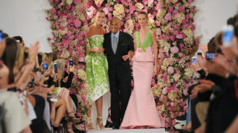 Designer Oscar de la Renta takes a bow with models Karlie Kloss (left) and Daria Strokous after his Spring 2015 collection was modeled Sept. 9 during Fashion Week in New York. De la Renta died on Oct. 20. (Diane Bondareff/AP)