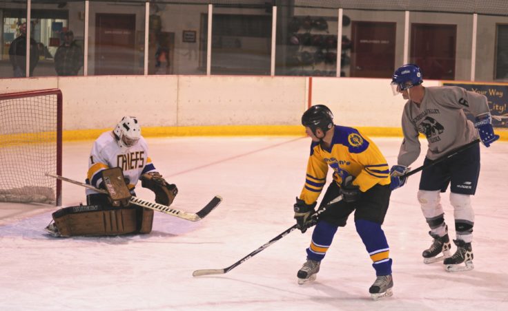 Mendenhall Valley’s Jason Soza tracks a shot attempt by Mike Svensson of Svensson Boatworks right into his chest pad.