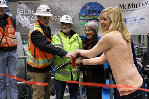 Representatives from McMillen LLC, Barnard Construction, and the city cut the ribbon, including (l to r) Andrew Pharis, Dean Orbison, Mim McConnell, Mark Gorman, and Jessica Stockel (Emily Kwong/KCAW photo).