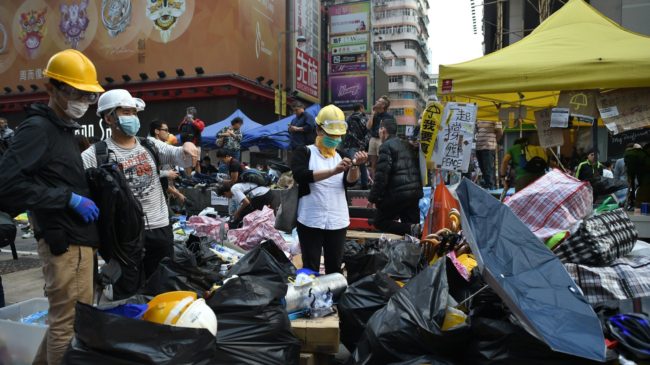  Protesters pack their belongings Wednesday ahead of an expected clearance by bailiffs and police at a pro-democracy protest site in the Mongkok district of Hong Kong. Philippe Lopez/AFP/Getty Images