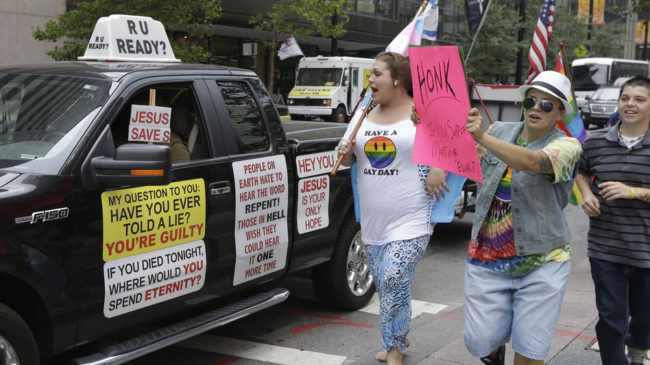 Gay-marriage supporters follow an opponent of same-sex marriage in August, when four courts argued to preserve their bans on the unions in a federal court in Cincinnati. The court confirmed the states' bans. Al Behrman/AP 