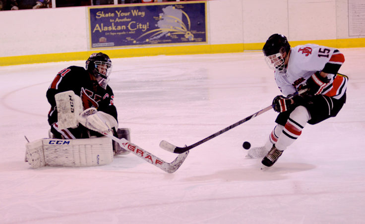 Juneau’s Cole Cheeseman bears down on Kenai goalie Nate O’Lena during one of several breakaways for Cheeseman over the weekend.