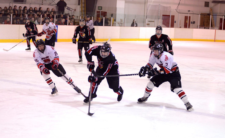 Juneau’s Corey Box (left) and Grant Ainsworth look to close the gap on Kenai’s Rilehy Weber during Friday night’s game.