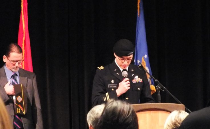 Chaplain Kirk Thorsteinson delivers the invocation as Cmdr. Dan McCrummen of VFW Post 5559 listens during Veterans Day observances at Centennial Hall on Nov. 11, 2014. (Photo by Matt Miller/KTOO)