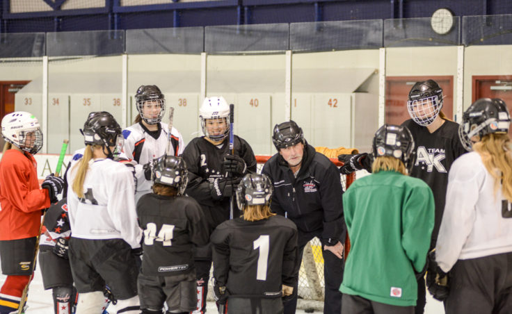 JDIA Coach Mark Kaelke listens closely while one of the more soft-spoken players introduces herself to start Kaelke’s all-girls clinic at Treadwell Ice Arena.
