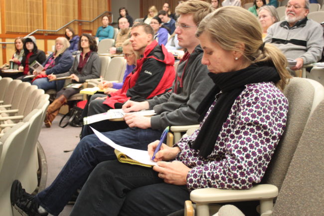 Many at the public meeting wrote comments down, often filling a page. (Photo by Lisa Phu/KTOO)