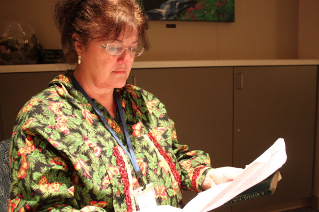 Claire Richardson is a volunteer chaplain at Bartlett Regional Hospital. She sits in the hospital's Prayer and Meditation room to collect herself before starting her volunteer shift. (Photo by Lisa Phu/KTOO)