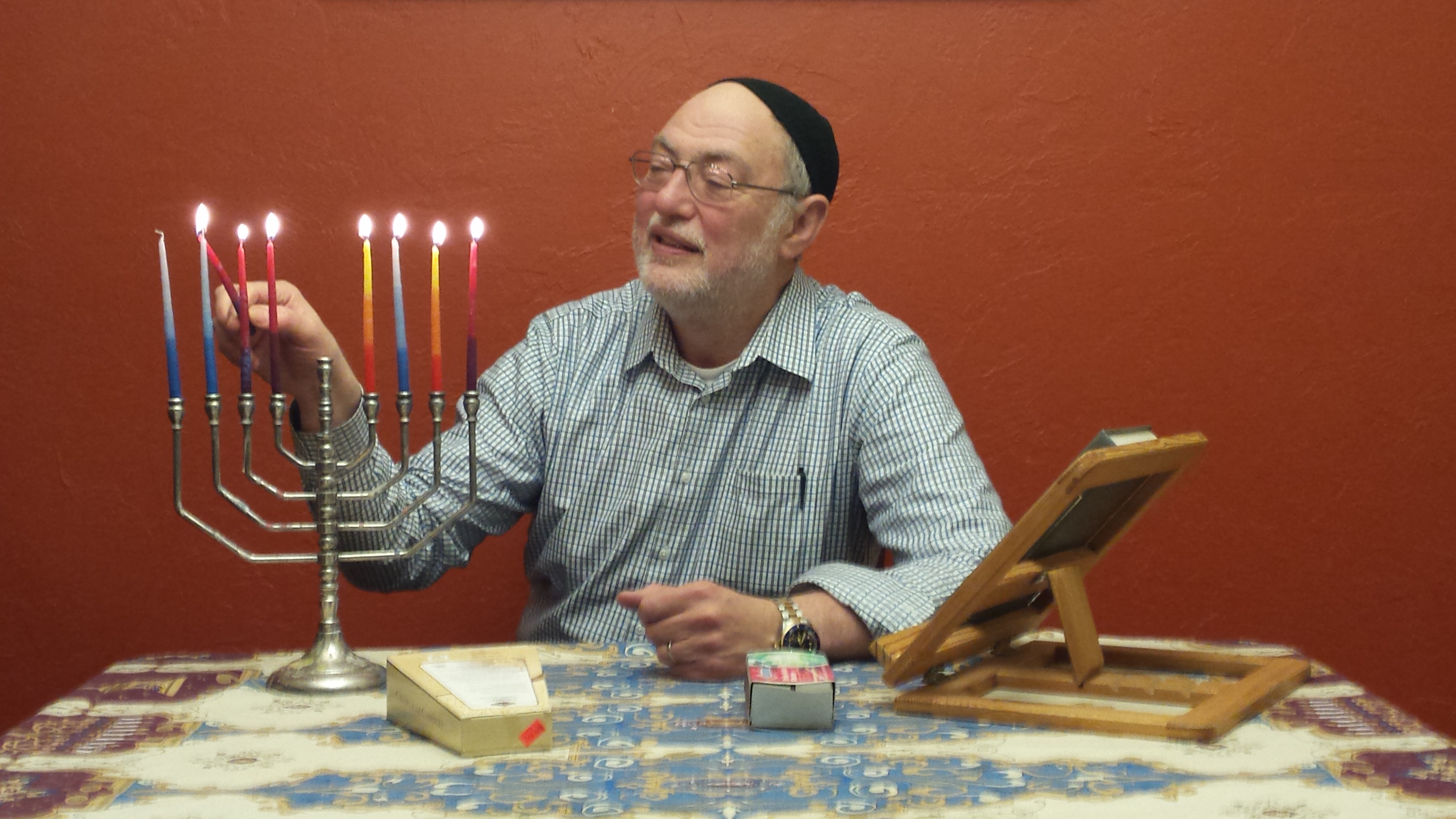 Rabbi Dov lights the menorah for Hanukkah (Photo by Kayla Desroches/KTOO)