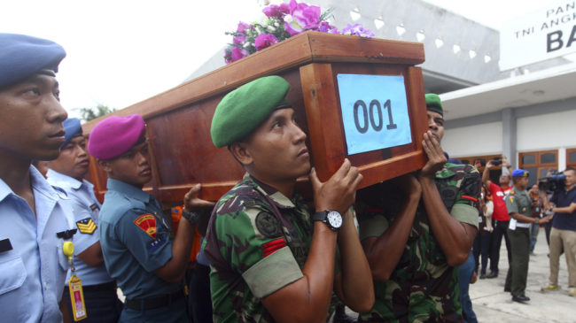 Indonesian soldiers carry a coffin containing a victim of AirAsia Flight 8501 upon arrival at Indonesian Military Air Force base in Surabaya, Indonesia, on Wednesday. Firdia Lisnawati/AP