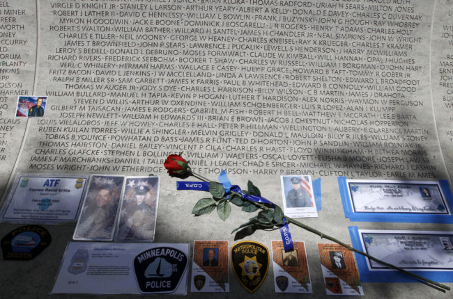 A rose is placed at the wall with the names of fallen police officers at the National Law Enforcement Officers Memorial in Washington during the National Police Week in 2013. Jose Luis Magana/AP