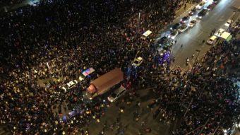 Emergency vehicles navigate the New Year's Eve crowd in Shanghai after a stampede by revelers in the historic riverfront district. At least 35 people were killed. AFP/Getty Images