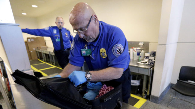TSA agents, like this one at Chicago's Midway International Airport, discovered more than 2,000 firearms at the nation's airports last year – the overwhelming majority of them loaded, according to new data. Nam Y. Huh/AP